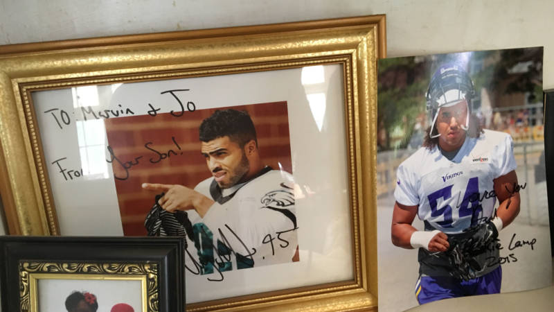 Marvin Kendricks cherishes signed photos of his sons, Mychal and Eric, both NFL players.