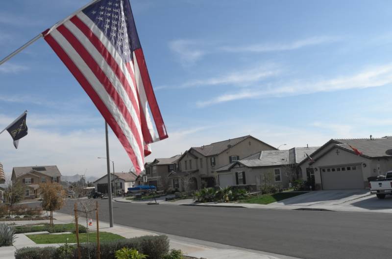 A flag flies in the neighborhood of Monument Park in Perris, Calif. 