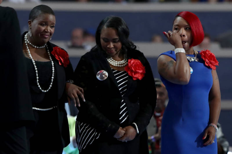 Left to right: Cleopatra Pendleton-Cowley, mother of Hadiya Pendleton; Wanda Johnson, mother of Oscar Grant; and Lezley McSpadden, mother of Mike Brown stand on stage prior to delivering remarks on the second day of the Democratic National Convention at the Wells Fargo Center, July 26, 2016, in Philadelphia. Johnson says she meets annually with other mothers who have lost loved ones to police violence.