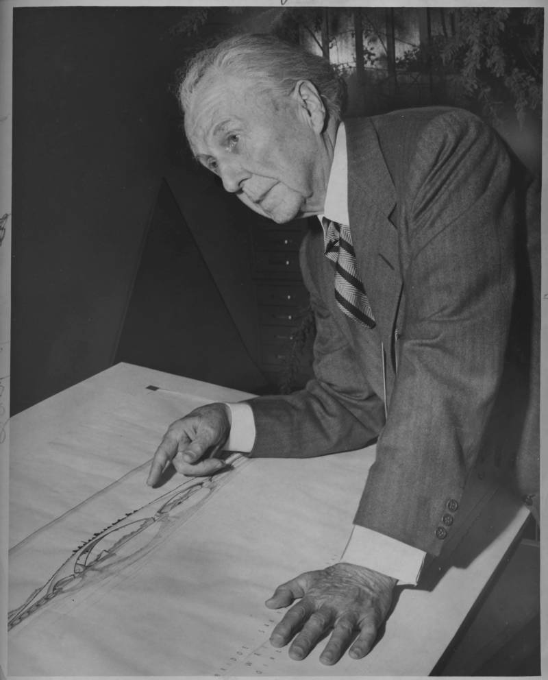Master architect Frank Lloyd Wright in 1956, looking over his drawing of the Butterfly Bridge.
