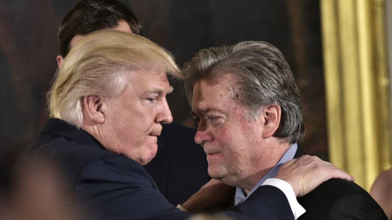 President Donald Trump congratulates Stephen Bannon during the swearing-in of senior staff in the East Room of the White House on January 22, 2017.