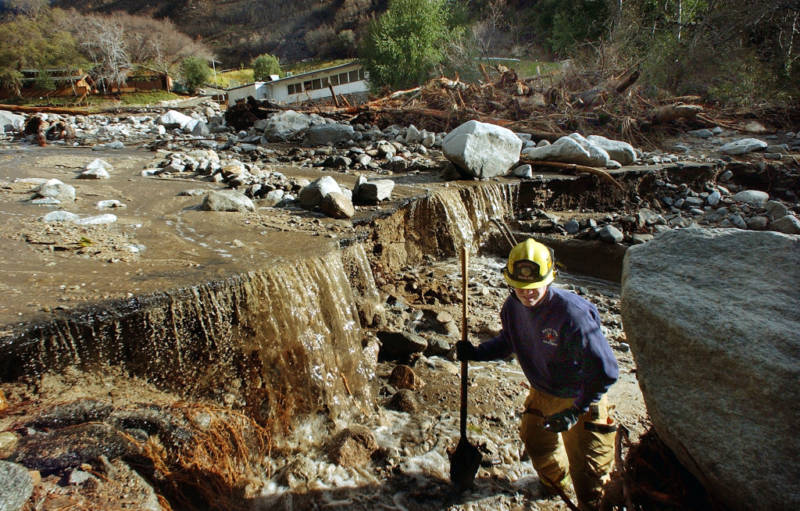 Rialto Firefighter Dave Denman searches for victims after a mudslide December 26, 2003 in Waterman Canyon, California. The mudslide which killed at least four, and left 12 missing was caused by heavy rains. 
