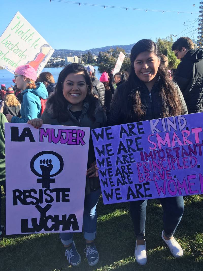 Mari Ana Flores (right) is at the Oakland Woman's March as a student of a St. Mary's College class called "Protest, Parade and Pop Music." She says the focus of class last week was Black Lives Matter, next week is Chicano rights, and this week is women.