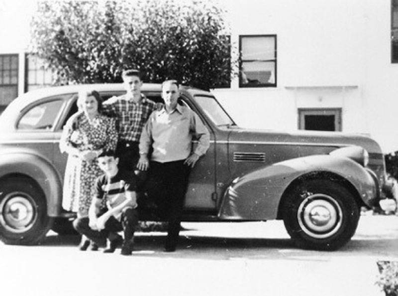 The Bronzini family: Clara, Al, Guido, and Lorenzo (in front), pose with their new 1939 Pontiac.
