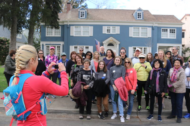 The "Lady Bird" walking tour group poses in front of the stately blue home from the film.