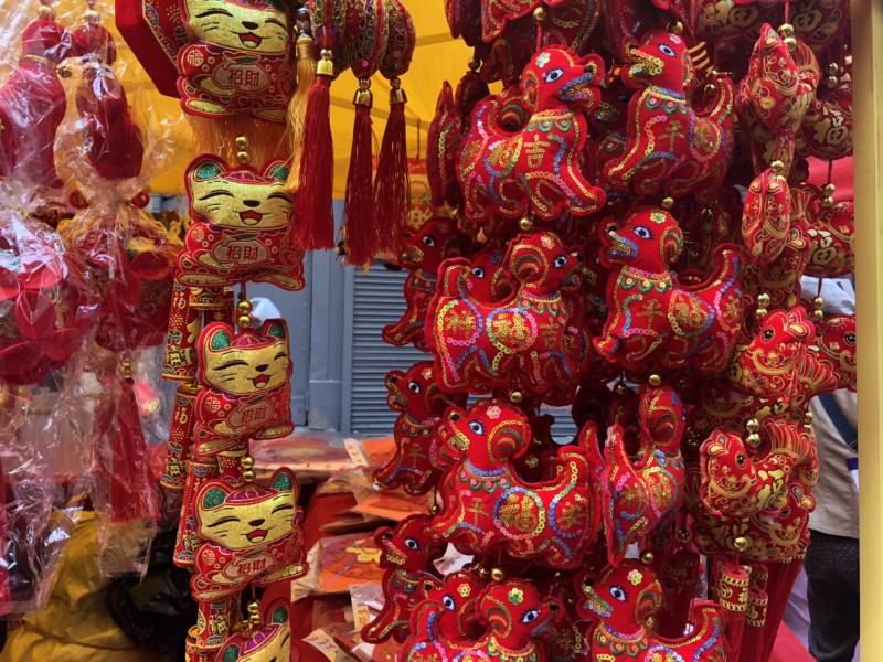 Merchandise featured motifs for the Lunar New Year of the Dog. Stalls selling decorations, plants and more lined a red and gold bedecked street in Chinatown.