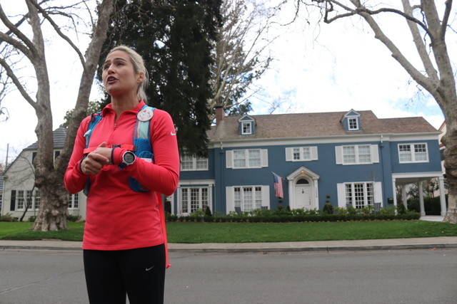 Tour guide Jenn Kistler-McCoy, founder of Sac Running Tours, showcases the iconic blue house to her walking tour.