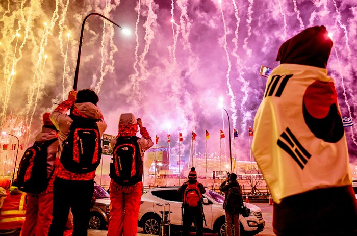 Spectators watch fireworks go off at the start of the opening ceremony.