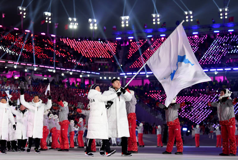 North and South Korean athletes enter together under the Korean unification flag during the parade of athletes.