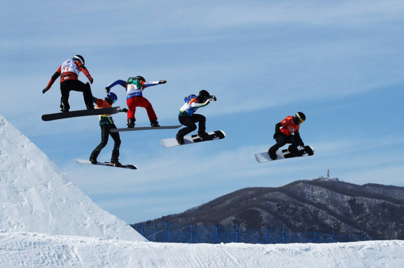 Men compete during the snowboard cross quarterfinals on Thursday.