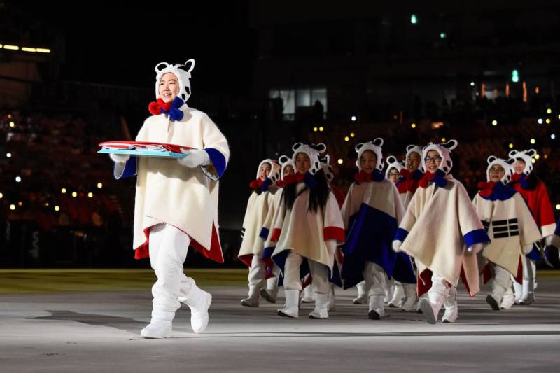 Performers deliver a South Korean flag.