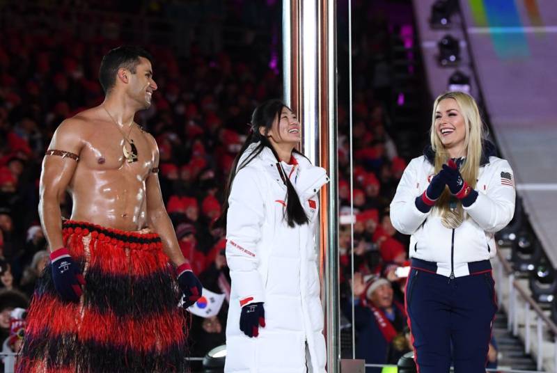 Tongan cross country skier Pita Taufatofua (left) once again marched bare-chested in frigid temperatures, and met onstage with China's silver medalist snowboarder Liu Jiayu and U.S. gold medalist Lindsey Vonn.