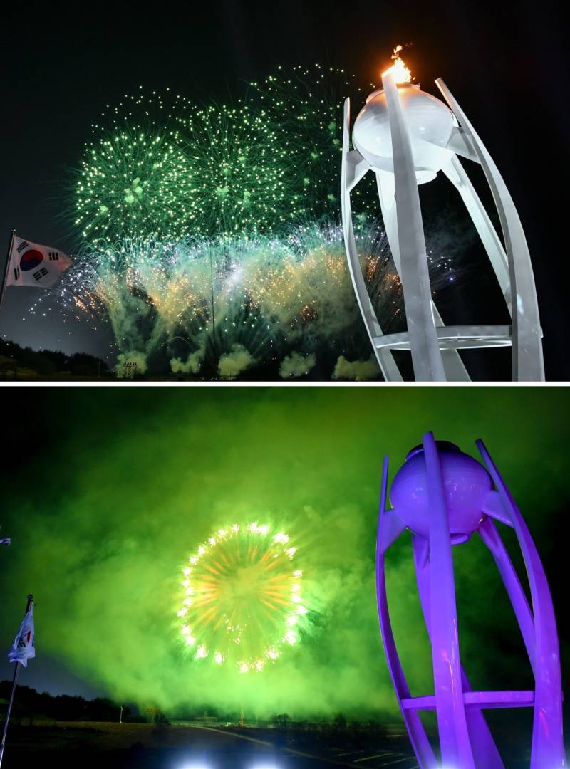 The Olympic flame is extinguished amid fireworks.