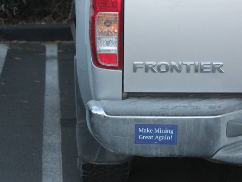 A "Make Mining Great Again" bumper sticker is visible on a pick-up truck outside a public meeting in Joshua Tree, California, on March 1, 2018, regarding a proposal to allow more mining and solar development in the desert. 