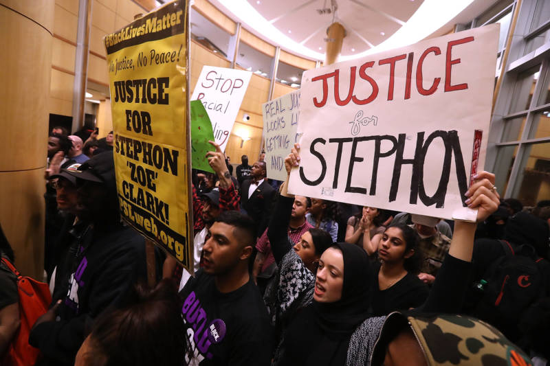 Protesters fill the lobby outside of the Sacramento City Council chambers to protest the police shooting death of Stephon Clark.