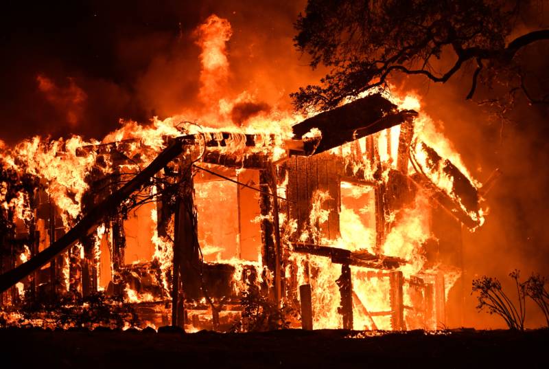 Flames ravage a home in the Napa wine region in California on October 9, 2017.