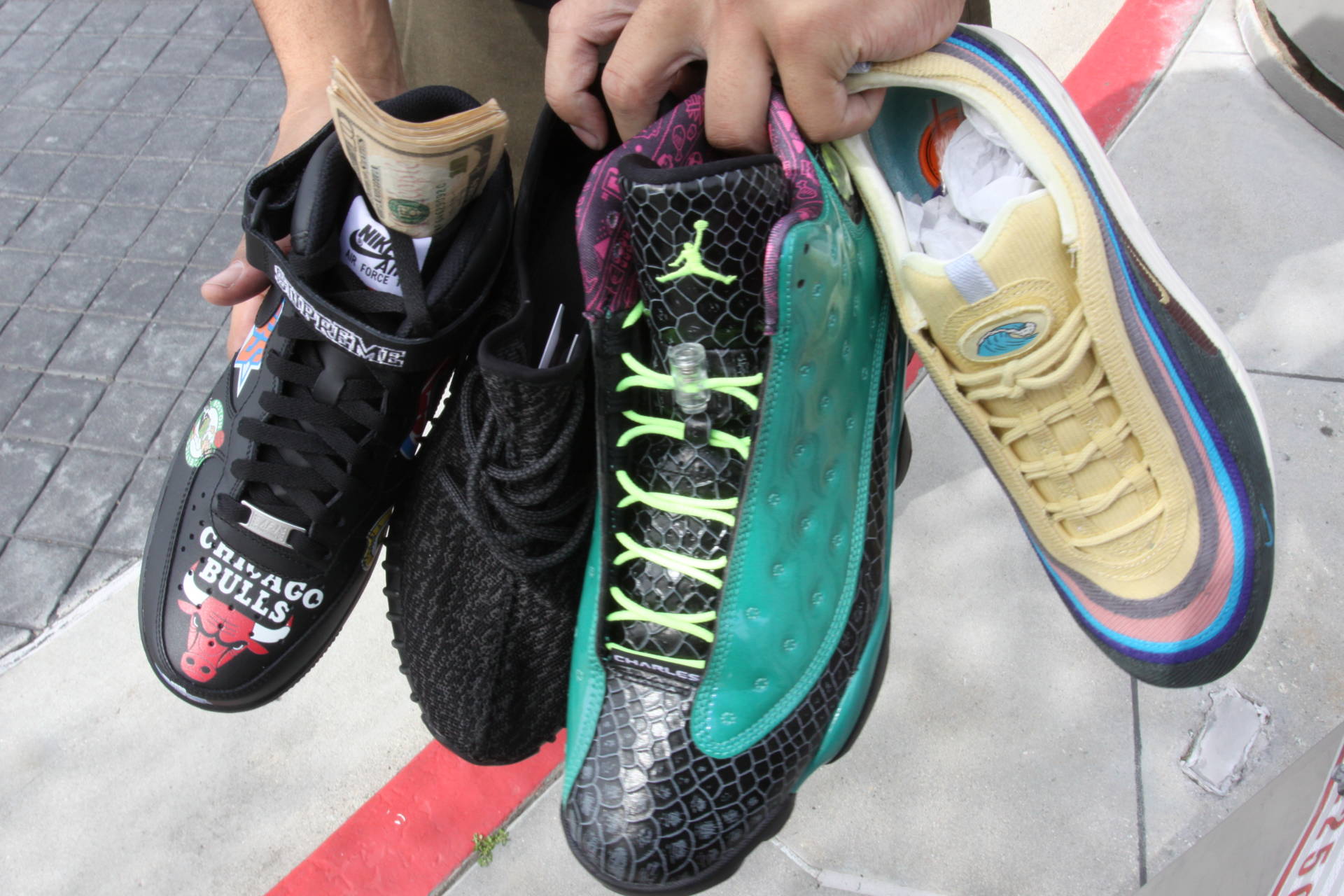 Attendees began to hawk shoes like these four sneakers while they were waiting in line for the doors to open at Sneaker Con on Saturday, March 31, 2018.