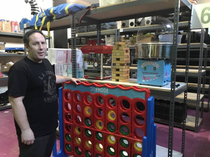 Joe Fernandez stands next to a giant Connect Four set in his company’s downtown Los Angeles warehouse. The Joymode co-founder says, among his customers, “Pretty much anything you can get giant versions of is really popular.” Feb. 5, 2018.