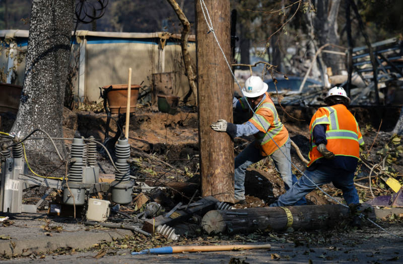 PG&E workers work to repair power lines in Santa Rosa's devastated Coffey Park neighborhood following the Tubbs Fire in October, 2017.