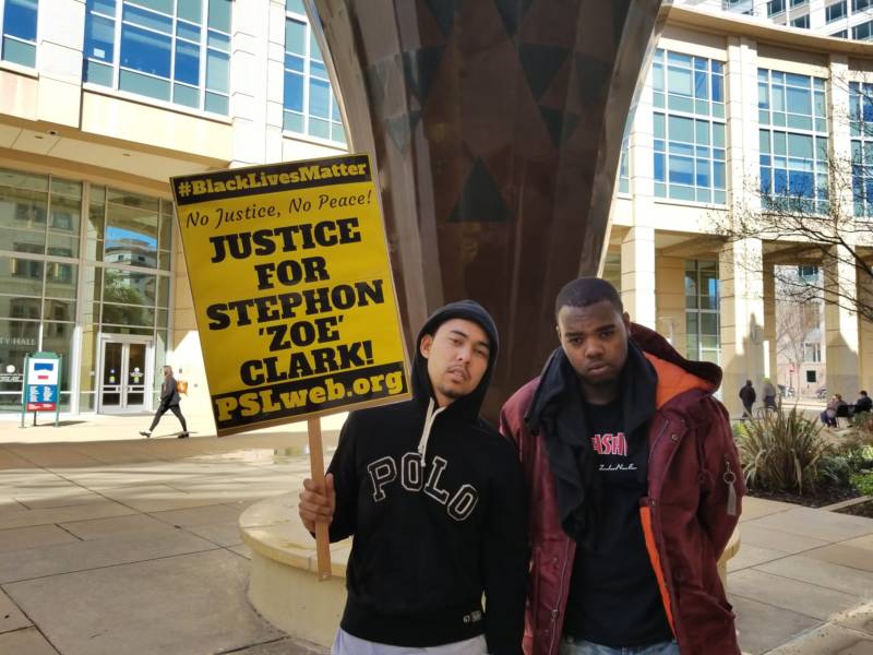 Anthony Cain and Clinton Primm, friends of Stephon Clark, rally outside Sacramento City Hall to protest his death.