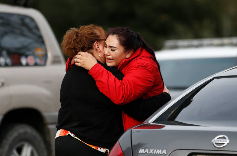 Vanessa Flores (R) embraces another woman after she leaves the locked down Veterans Home of California during an active shooter turned hostage situation on March 9, 2018 in Yountville.