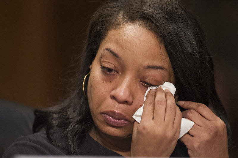 Kubiiki P. wipes tears as she testifies at a 2017 Senate hearing, speaking about her young daughter being sold for sex on Backpage.com.