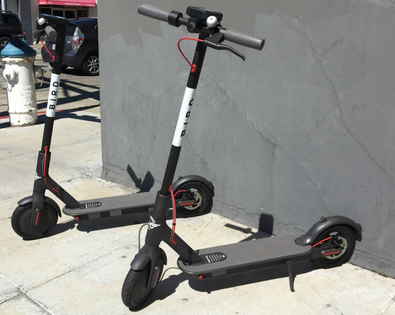 Two scooters from Southern California startup Bird on a sidewalk near Fifth and Brannan streets in San Francisco.