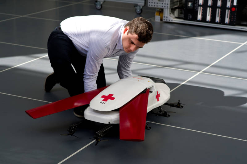 Graduate researcher Chris Dougherty prepares a scale model air ambulance robot for a demonstration flight.