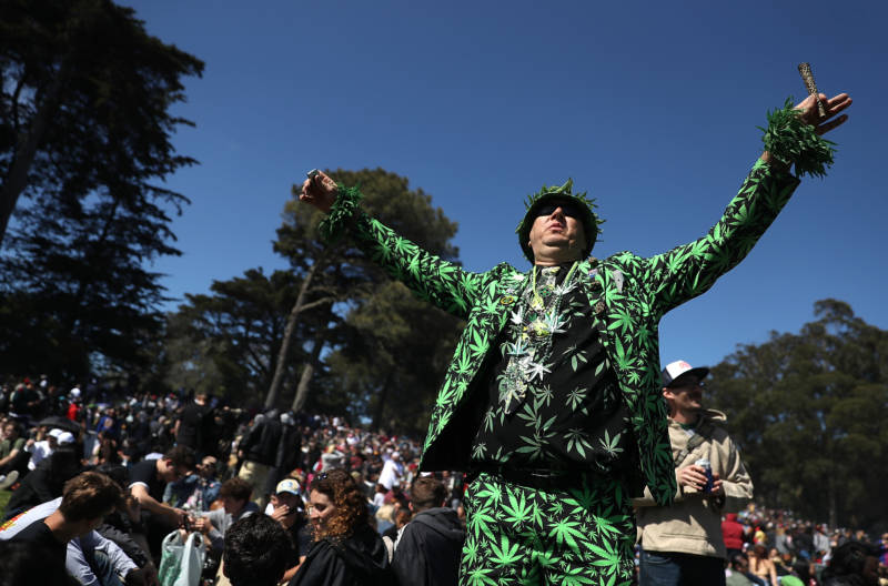 A marijuana user wears a marijuana themed outfit during a 420 Day celebration on 'Hippie Hill.'