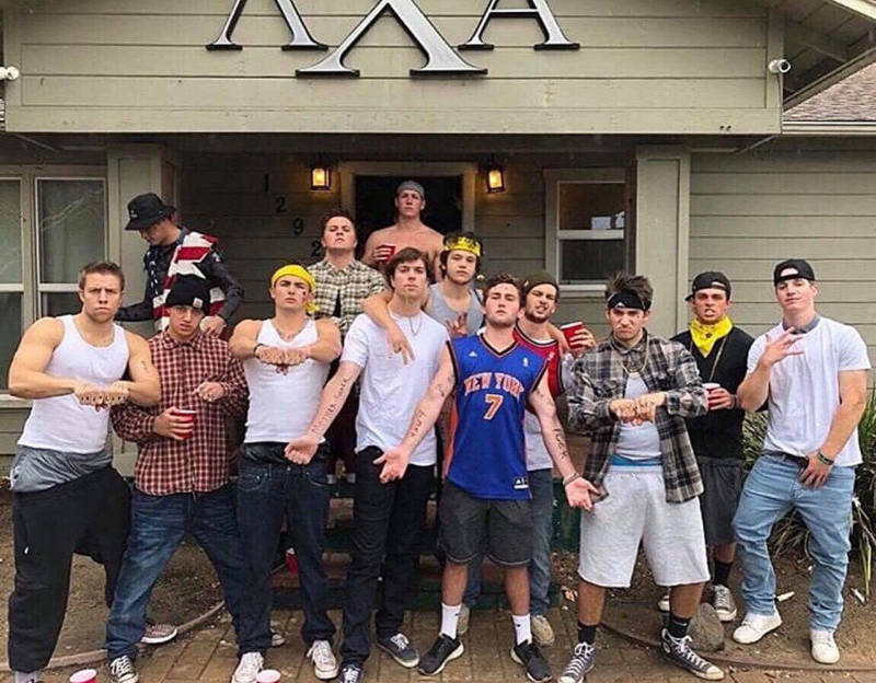 Members of the Cal Poly Lambda Chi Alpha chapter stand in front of their fraternity house dressed as gang members.