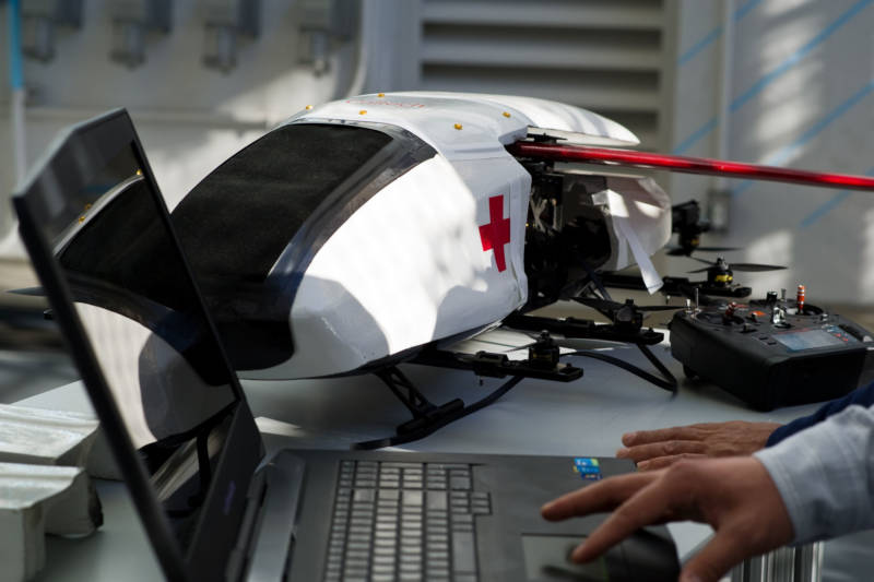 The scale-model ambulance robot sits on a desk at Caltech's CAST lab.