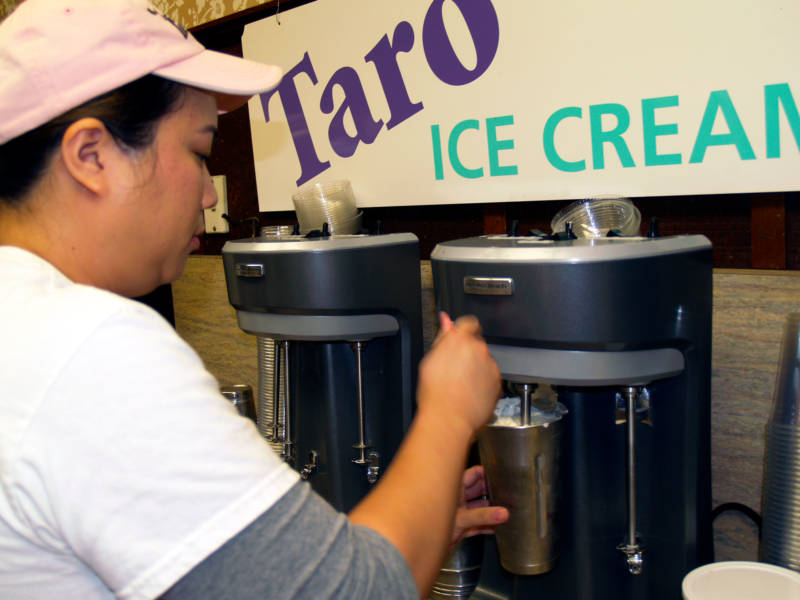 A Fosselman's manager makes a shake, below a sign advertising Taro ice cream.