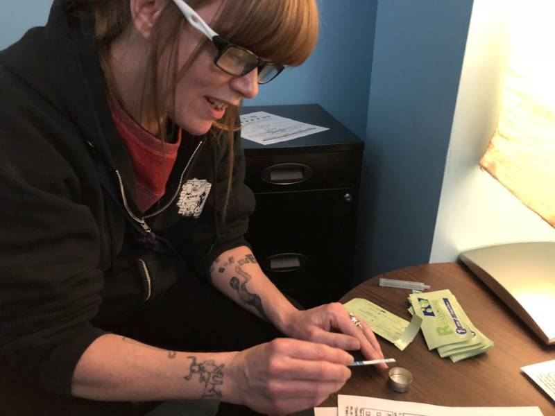 Terry Morris, director of the 6th Street Harm Reduction Center, demonstrates how to test a drug for the presence of fentanyl with a fentanyl test strip.