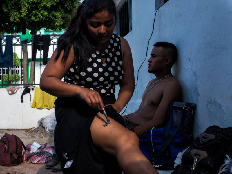 Estela, 30, shaves her legs at a church in Mazatlán after traveling for three days on a freight train, Oct. 24, 2017.