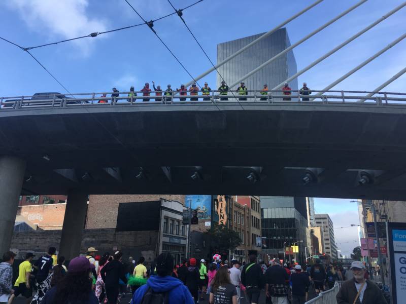 A crew of construction workers cheered on race participants from a Bay Bridge on-ramp in downtown San Francisco.