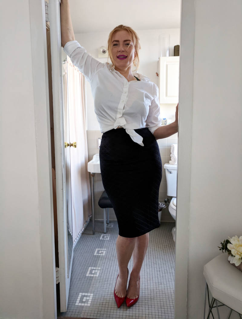 Grace, posing in the doorway of her bathroom, dressed for a patron who she was meeting later that day. Her mother and son did not want to be photographed for this story.