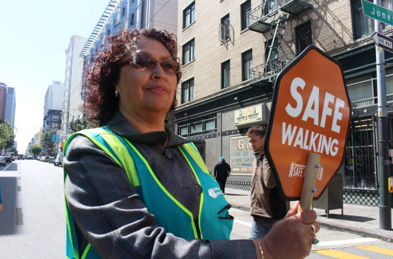 Margarita Mena, 60, stops traffic for pedestrians in San Francisco’s Tenderloin neighborhood on April 24, 2018. Mena, a Tenderloin resident, helped start the Safe Passage program.