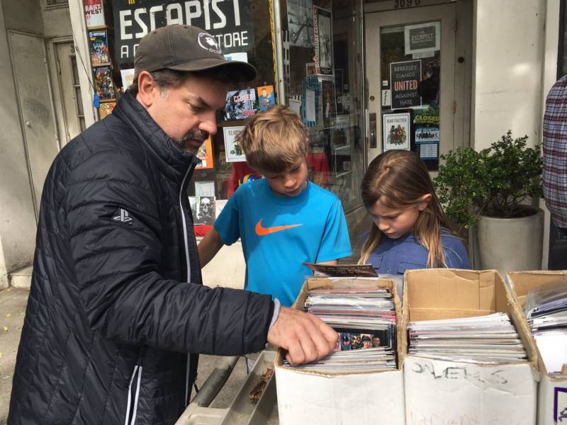 Mike Mika and his kids Ellis and Emerson, from Berkeley, look for Avengers comics at the Escapist Comic Bookstore in Berkeley on Saturday, May 5, 2018.