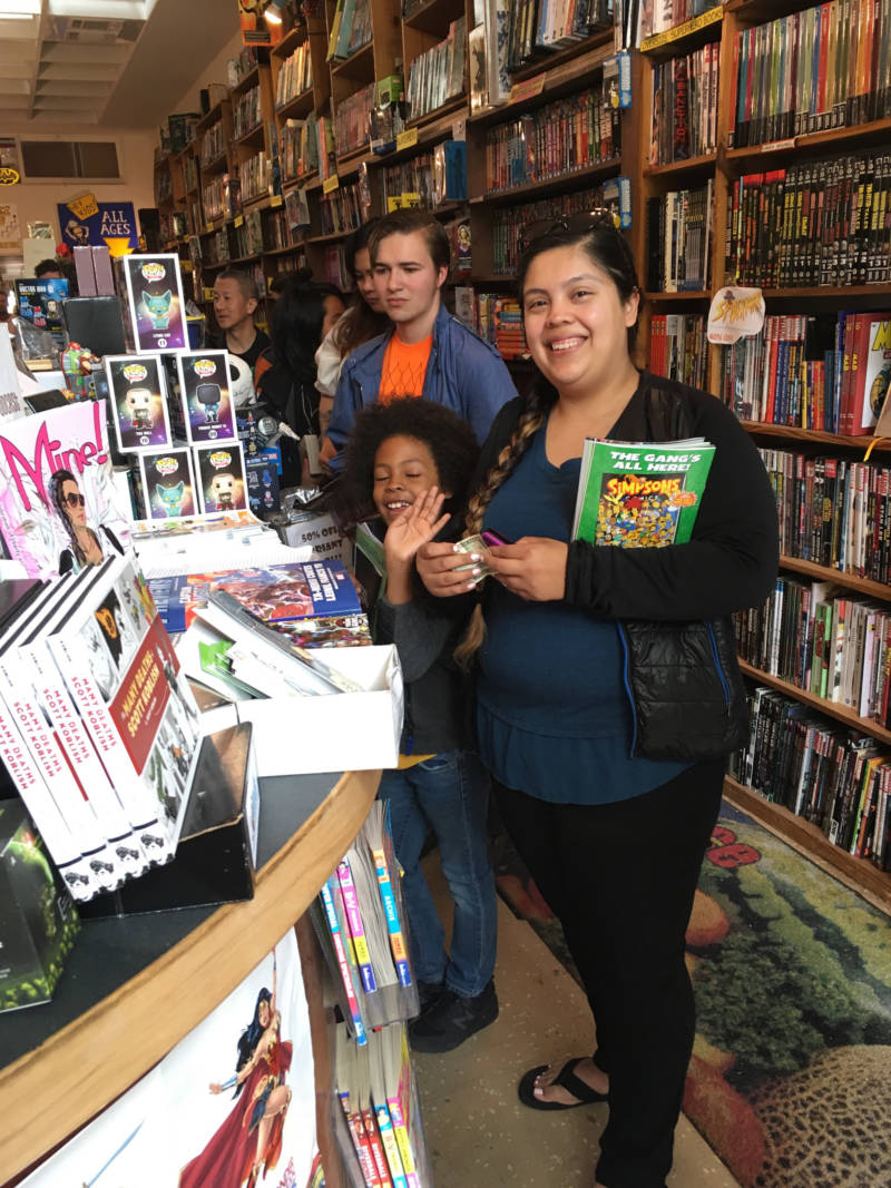 Ché and his mom Sylvia Avalos are at the Escapist Comic Bookstore in Berkeley. When asked if comics have people that look like him in them, he said, "Hmmm, maybe one...with puffy hair like me!"