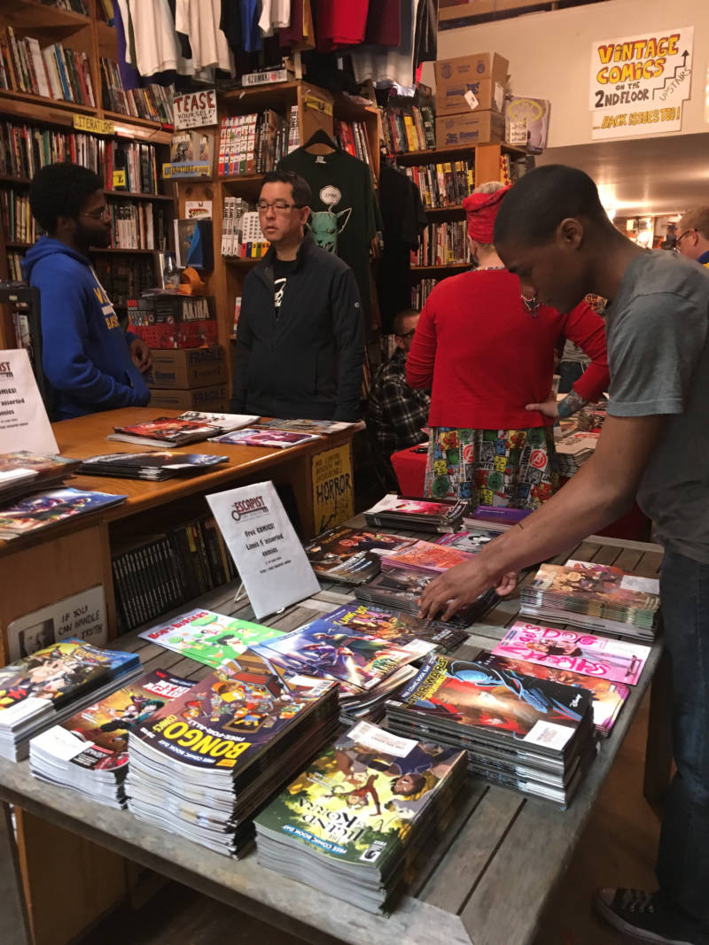 Comic book fans browse the collection at the Escapist Comic Bookstore.