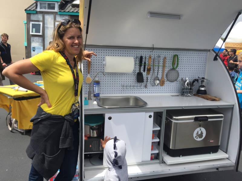 Jaime Goodrich, head tinkerer of Tinkerdrop, stands beside the back of her DIY trailer, complete with a full kitchen. She was selling kits that would allow anyone to make their own live-in trailer.