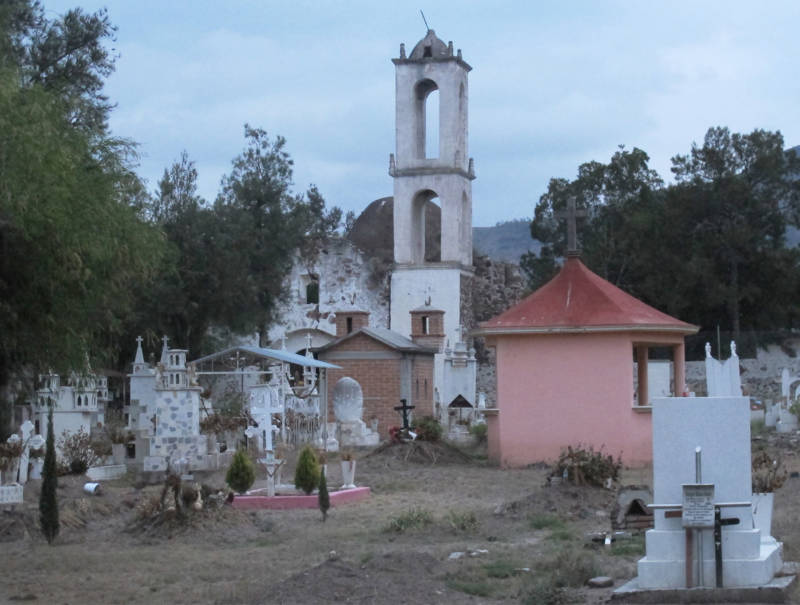 A church rises behind the cemetery in Santa Monica, Hidalgo.