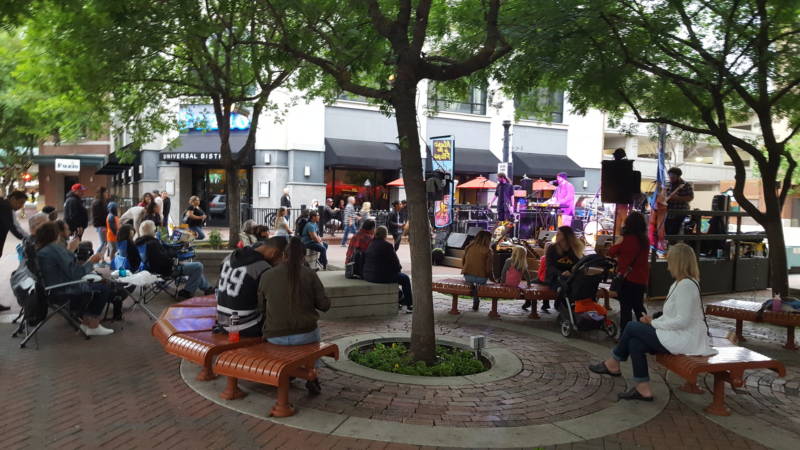 People gather for a public concert in Modesto's 10th Street Plaza.