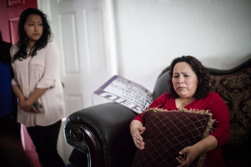 Maria Mendoza-Sanchez sits on a couch in her Oakland home on Aug. 16, 2017, hours before she, her husband and son leave Oakland for Mexico City. Her daughter, Melin Sanchez, 21, cries as she watches her mother with concern.