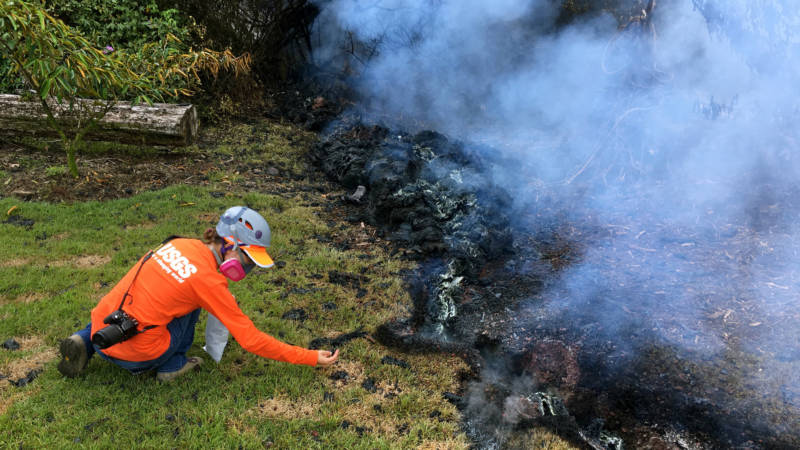 Hawaiian Volcano Observatory geologists collect samples of spatter for laboratory analysis on Sunday in the Leilani Estates subdivision near Pahoa, Hawaii.