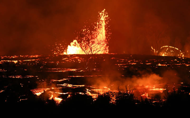 Lava erupts and flows from a Kilauea fissure on Friday in Kapoho, on Hawaii's Big Island.