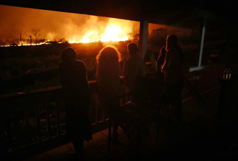 Residents view lava erupting from one of Kilauea's fissures, at a small viewing party on a neighbor's porch, on Hawaii's Big Island.
