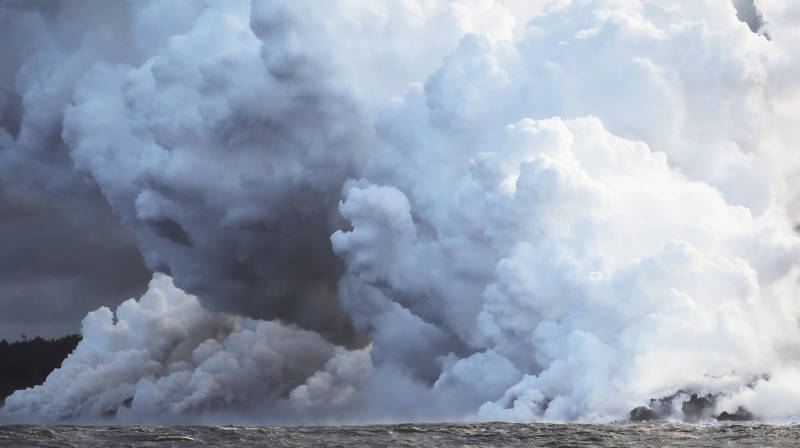 Steam plumes rise as lava from Kilauea enters the Pacific Ocean. Officials are warning residents to stay away from plumes of laze, which consists of hydrochloric acid and steam with fine glass particles.