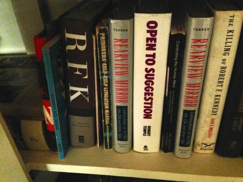 The book shelf in the Sirhan family home, including Munir's Kennedy volumes and his brother Sirhan's copy of "Controlling the Human Mind." Sirhan was interested in hypnotism at the time of the assassination.