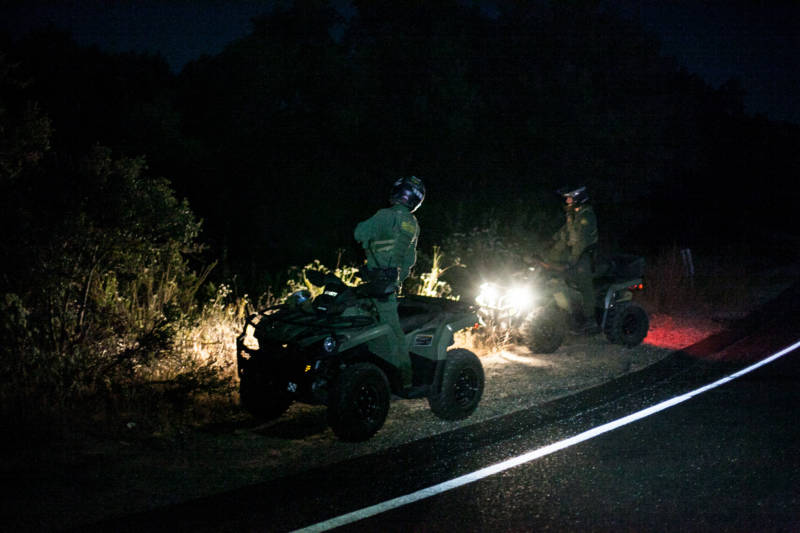 Early morning border patrol agents search for people near the Tecate - U.S. border. Someone left a marker for the people coming over to the U.S. side so they know where to go. 